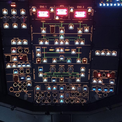 aircraft cockpit control panel with multiple buttons and indicators featuring three engine controls and emergency lights
