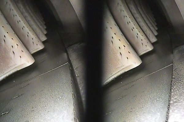 cross section of a tire showing tread pattern and inner structure featuring three distinct layers and details